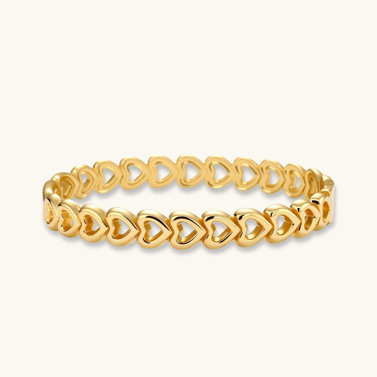 Gold 18K plated stainless steel bangle with continuous open heart links, high-polish finish, on white background.